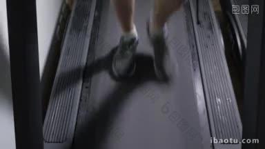 成年男子穿着运动鞋在跑步机上走，然后开始跑步的脚近距离